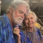 A man and woman pose for the camera.