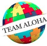 A globe with puzzle pieces that say team aloha.